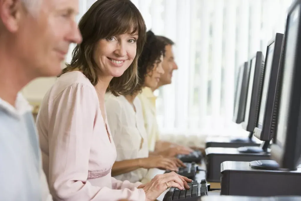 Woman in a computer lab smiling at the camera